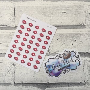 May include: A sheet of red lip stickers with the text "Dood Plook Designs" and "DPD-592" on a white brick background.