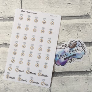 May include: A sheet of white sticker paper with 30 diamond ring stickers. Each sticker has a gold ring with a diamond and a number from 1 to 30. The stickers are arranged in rows of five. The sheet also includes stickers with the text "1 Month", "2 Months", "3 Months", "4 Months", "5 Months", "6 Months", and "1 Year".