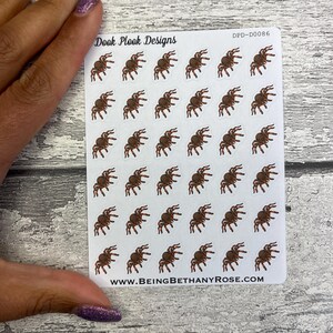 May include: A sheet of 36 brown spider stickers on a white background. The stickers are arranged in a grid pattern. The text "Dook Plook Designs" and "www.beingbethanyrose.com" are printed on the sheet. The text "DPD-D0086" is printed in the top right corner.