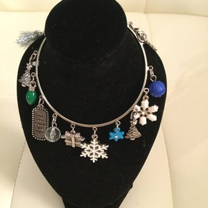 Bracelet - Christmas Holiday Silver Charm Bracelet.  Holiday Charms hang individually from a slip-on bracelet.  Silk Pouch is Included.