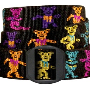 May include: Black woven belt featuring a repeating pattern of colorful dancing bears in shades of purple, orange, yellow, and teal. The belt has a black plastic buckle. The belt is approximately 1.5 inches wide.