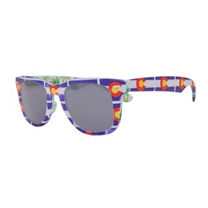 May include: A pair of sunglasses with a white frame and blue and red patterned design featuring the Colorado state flag. The lenses are dark gray.