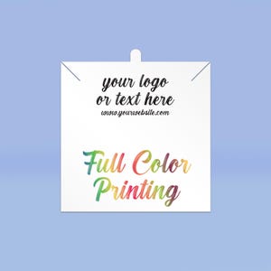May include: White square tag with a hole at the top. The tag has black text that says "your logo or text here www.yourwebsite.com". Below the text is the phrase "Full Color Printing" in rainbow colors.