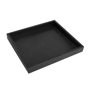 May include: A black square tray with a smooth surface and a raised edge.