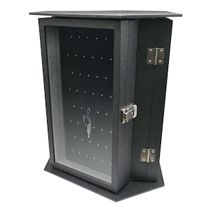 May include: Black hexagonal display case with a glass door and a lock. The case has a black interior with multiple holes for displaying small items.