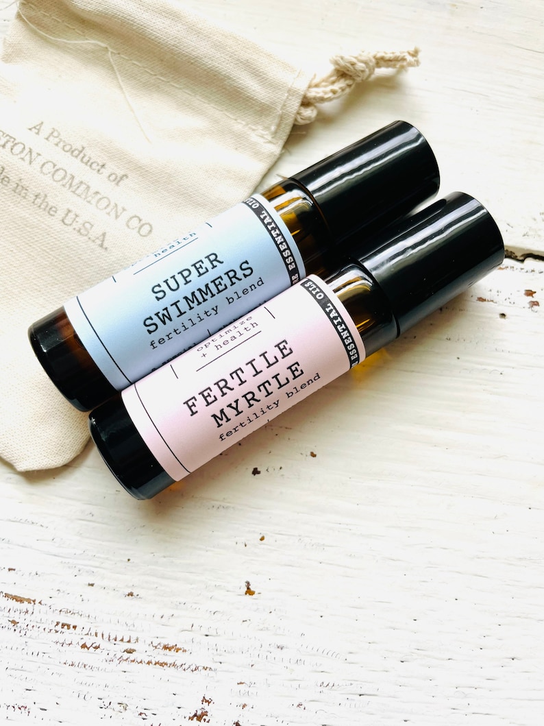 May include: Two small glass bottles with black roll-on tops. The bottles are labeled "Super Swimmers fertility blend" and "Fertile Myrtle fertility blend".