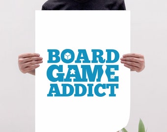 May include: A white poster with the text "BOARD GAME ADDICT" in blue letters. The text includes a game piece, a dice, and a box icon.