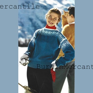 Puede incluir: Una mujer con un suéter azul y blanco con un patrón y una bufanda roja, de pie en un paisaje nevado. El texto "BurginMercantile" aparece dos veces en la imagen.