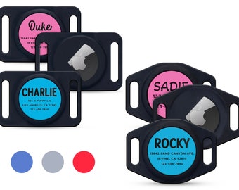 May include: Four black dog ID tags with different colored backgrounds and names. The tags have a black buckle and a white paw print. The names on the tags are Duke, Charlie, Sadie, and Rocky. The colors are pink, blue, light pink, and light blue.