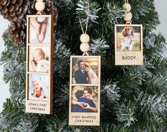 May include: Three wooden photo ornaments with twine hangers and wooden beads. The ornaments feature photos of a baby, a couple, and a dog. The ornaments have text that reads "Noah's First Christmas", "First Married Christmas", and "Buddy".