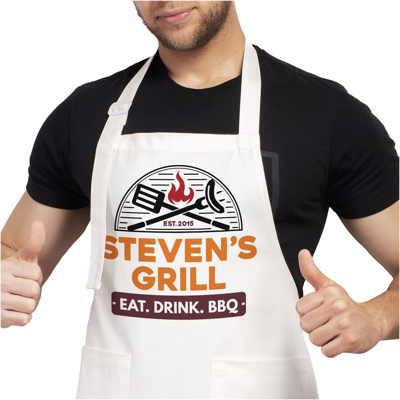 May include: White apron with a red, orange, and black logo that says "Steven's Grill - Eat. Drink. BBQ -" and "Est. 2015".