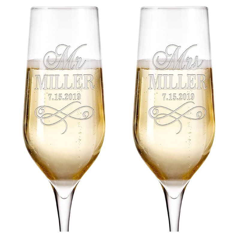May include: Two champagne flutes with the words "Mr. MILLER 7.15.2019" and "Mrs. MILLER 7.15.2019" etched on them.