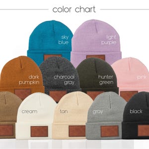 May include: Color chart of 12 beanie hats in various colors, including sky blue, light purple, dark pumpkin, charcoal gray, hunter green, pink, camel, cream, tan, gray, and black. Each beanie has a leather patch.