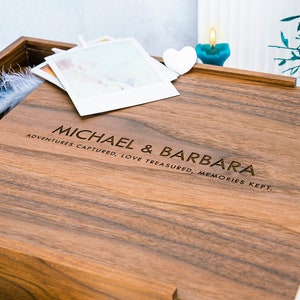 May include: A wooden photo box with the inscription "MICHAEL & BARBARA ADVENTURES CAPTURED, LOVE TREASURED, MEMORIES KEPT."