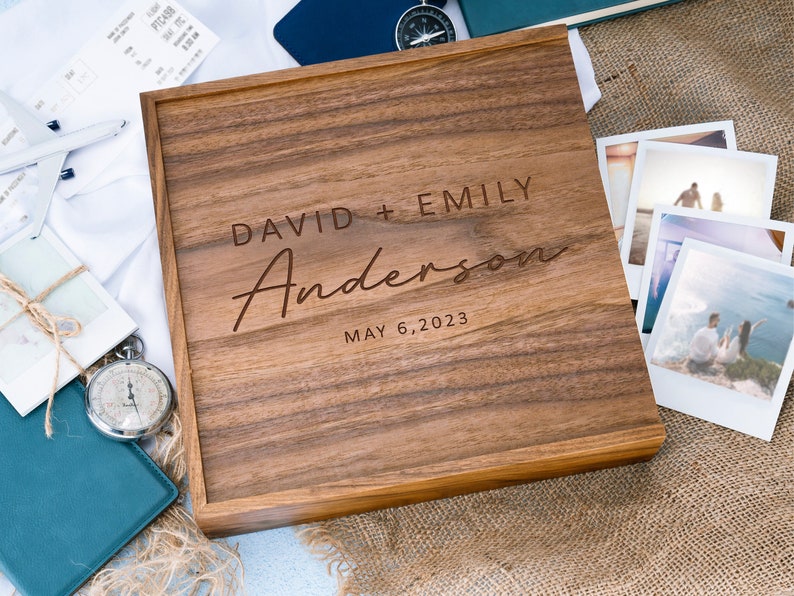 May include: A wooden box with a personalized inscription for a wedding. The inscription reads "David + Emily Anderson May 6, 2023".
