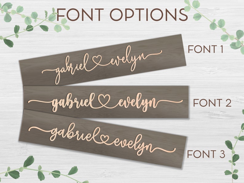 May include: Three wooden signs with different font styles showing the names "gabriel" and "evelyn" with a heart symbol between them. The signs are labeled "FONT 1", "FONT 2", and "FONT 3".