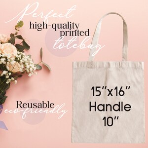 May include: A natural-colored canvas tote bag with black text that reads "15"x16" Handle 10". The bag is on a pink background.