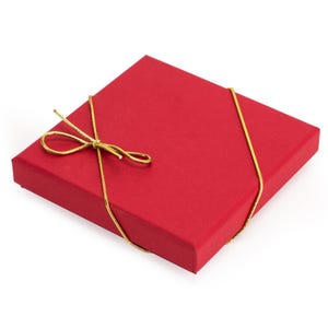 May include: A red gift box with a gold ribbon tied in a bow.