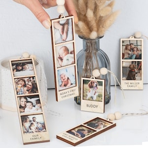 May include: Wooden photo ornaments with string for hanging.  The ornaments feature multiple photos in a vertical strip.  The text on the ornaments reads "Our Family", "Noah's First Christmas", "Buddy", "First Married Christmas", and "The Miller Family".