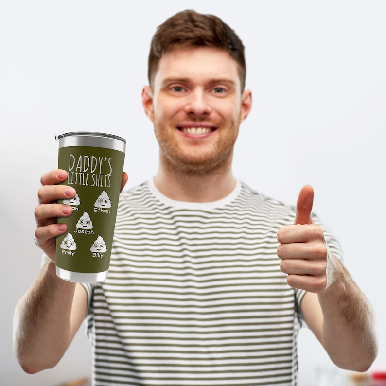 Op de afbeelding: Een roestvrijstalen tumbler met een groene achtergrond en witte tekst die "Daddy's Little Shits" zegt. De tumbler heeft een witte afbeelding van een hoop poep met een gezicht en de namen "Ethan", "Joseph", "Billy" en "Emily" eronder geschreven.