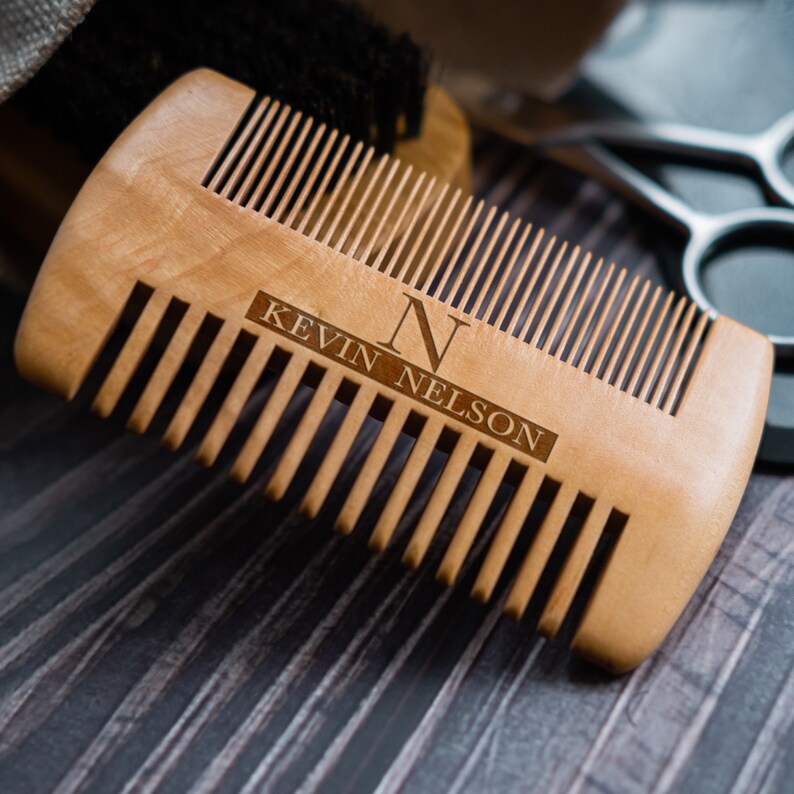 May include: A wooden comb with a personalized inscription that reads "N KEVIN NELSON". The comb has a natural wood finish and is made of high-quality wood.