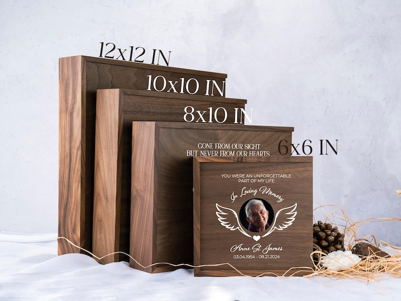 May include: Four wooden shadow boxes in different sizes, 12x12 inches, 10x10 inches, 8x10 inches, and 6x6 inches. The smallest box has a photo of a person with the text "Gone from our sight but never from our hearts. You were an unforgettable part of my life. In loving memory. Anne St. James 03.04.1954 - 08.21.2024."