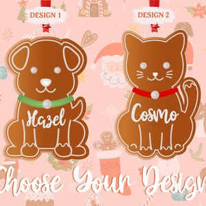 May include: Two gingerbread ornaments, one shaped like a dog and the other like a cat. The dog ornament has a green collar and the text "Hazel" on it. The cat ornament has a red collar and the text "Cosmo" on it. Both ornaments are on a pink background with a Christmas theme.