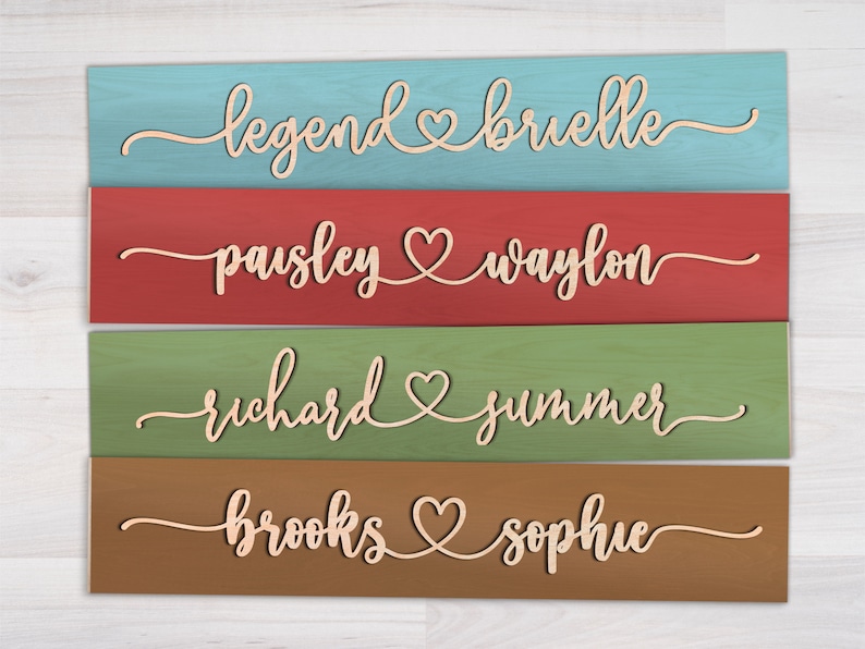 May include: Four wooden signs with different colored backgrounds and the names of couples written in cursive with a heart symbol between each name. The names are: Legend & Brielle, Paisley & Waylon, Richard & Summer, Brooks & Sophie.