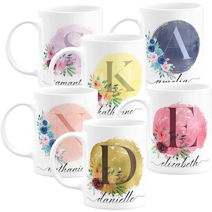 May include: Set of six white ceramic mugs with floral designs and a single letter in a watercolor circle. The mugs are personalized with names: "Samantha", "Kathrine", "Amelia", "Nathania", "Elizabeth", and "Danielle".