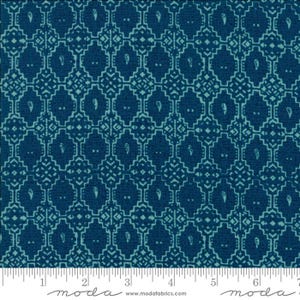 May include: A close-up of a fabric with a repeating geometric pattern in shades of blue. The design features diamond shapes with paisley-like details and a grid-like background. The fabric is likely cotton or a similar material.