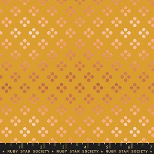 May include: Mustard-colored fabric with a repeating pattern of four-dot clusters in a diamond arrangement. The dots transition from a light pink to a darker rose gold hue. The text "RUBY STAR SOCIETY" is at the bottom.
