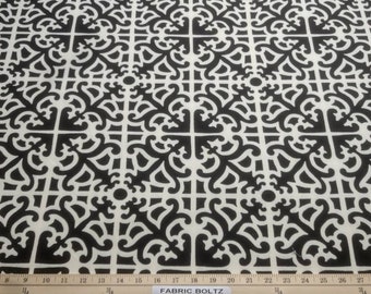 May include: Black and white fabric with a repeating geometric pattern. The pattern is made up of intricate, stylized shapes that resemble a lattice or trellis.