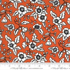 May include: Orange fabric with a repeating floral pattern. White flowers with black centers and black stems and leaves are scattered across the fabric. The fabric has a ruler along the bottom with the text "moda" and "www.modafabrics.com".