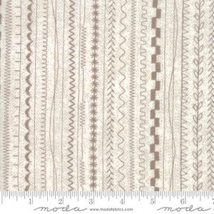 May include: Cream-colored fabric with a repeating pattern of various stitched designs in shades of brown. The designs include zigzags, straight stitches, and decorative patterns. The fabric is suitable for quilting and sewing projects.