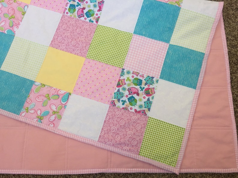 Bright Owls baby quilt in pink teal white and lime green yellow
