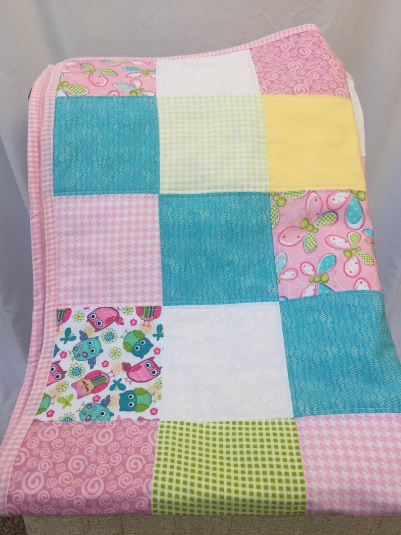 Bright Owls baby quilt in pink teal white and lime green yellow
