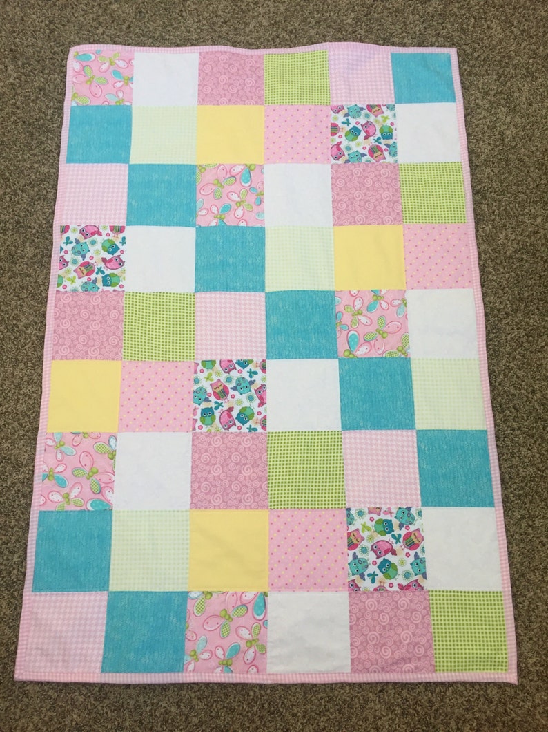 Bright Owls baby quilt in pink teal white and lime green yellow