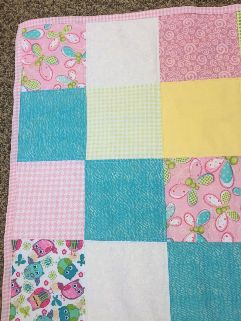Bright Owls baby quilt in pink teal white and lime green yellow