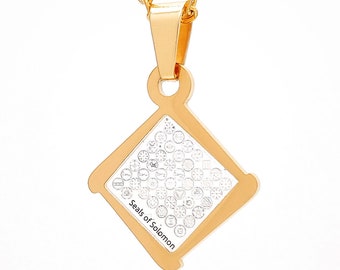 May include: Gold chain necklace with a square pendant featuring a silver design of the Seals of Solomon.