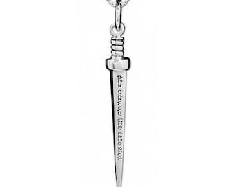 May include: A silver-colored pendant necklace featuring a dagger-shaped charm. The charm has engraved text and is suspended from a delicate chain. The dagger design is detailed, with a handle and a pointed blade.