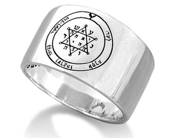 May include: A silver ring with a sigil engraved on the top. The sigil is a six-pointed star with Hebrew lettering around it. The ring is a wide band with a flat top.