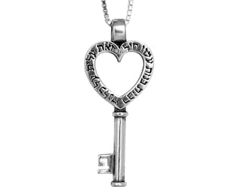 May include: A silver key pendant necklace with a heart-shaped keyhole and Hebrew text around the edge.