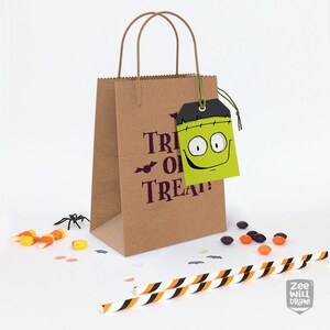 May include: A brown paper bag with the words "Trick or Treat" in purple. A green tag with a Frankenstein face hangs from the bag. Candy corn, a plastic spider, and striped straws are scattered around.