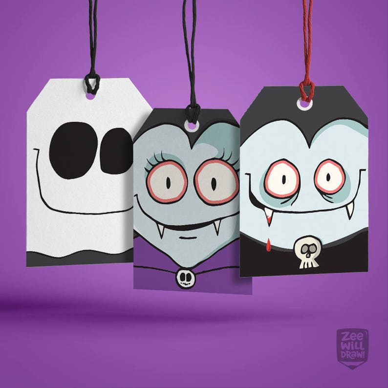 May include: Three Halloween-themed gift tags with black strings. The tags feature cartoon illustrations of a ghost, a female vampire, and a male vampire. The ghost is white with black eyes and a smiling mouth. The vampires have pale skin, fangs, and are wearing capes.