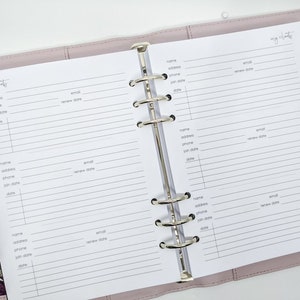 May include: A white planner with a pink cover and gold rings. The planner has pages for listing client information, including name, address, phone number, email, join date, and renewal date. The planner has the words "my clients" written at the top of each page.