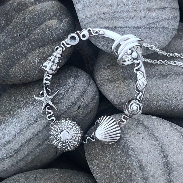 Oval Silver Sea-life Garland. Hand-sculpted in 999 fine silver, each tiny shell, starfish and urchin bringing memories of the sea.