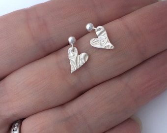 Tiny Heart Drop Stud Earrings, handmade in fine silver and embossed with a floral pattern.