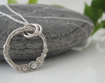 Handmade Dimples Necklace made in Fine Silver. An open ring with dinky dimple details!