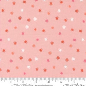 May include: Pink fabric with a white and orange star pattern.