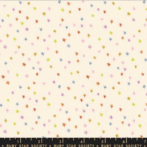 May include: A white fabric with a repeating pattern of small, colorful stars. The stars are in shades of yellow, orange, pink, and blue.
